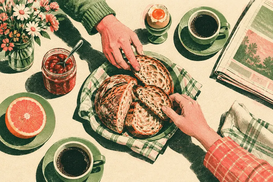 Von oben: ein Frühstückstisch mit Ei, frischem Brot, Marmelade, Orange und Kaffee, zwei Hände greifen nach dem Brot